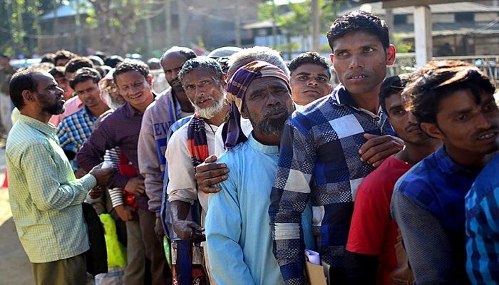 
People stand in line to check their names on the first draft of the National Register of Citizens in the Indian state of Assam on January 1, 2018. PHOTO: KULENDU KALITA/AFP
