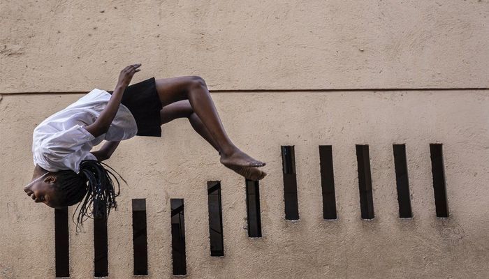 This girl does a backflip in South Africa on one of the free trampolines in Johannesburg's Alexandra township after school on Tuesday...
