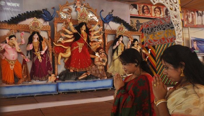 Devotees offer prayers to the goddess Durga at Ramna puja mandap in Dhaka on Friday. Photo: Collected