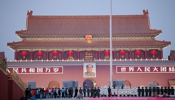 Chinese honour guards stand in formation during the lowering of the national flag in front of Tiananmen Gate in Beijing on Monday, September 30, 2019 AFP