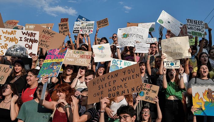 People hold placards as they participate in a "Fridays For Future"rally, a global series of protests to avert a climate catastrophe, in central Athens on September 27, 2019 photo: AFP