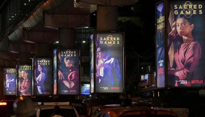 Traffic moves on a road past hoardings of Netflix`s new television series `Sacred Games` in Mumbai, India, Jul 11, 2018. REUTERS