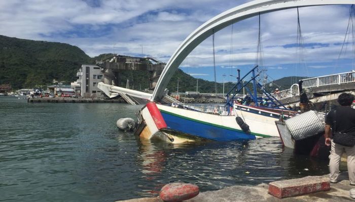 The collapse of the bridge, which carries traffic over the busy fishing port, damaged three fishing boats and two vehicles. Photo: Collected