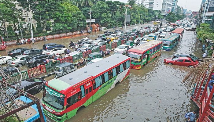 Vehicles are caught in long tailbacks on the waterlogged Mirpur Road near Dhanmondi-27 intersection after a downpour flooded the capital yesterday afternoon. Such rain often spells trouble for city dwellers mainly due to a poor drainage system. Photo: Collected.