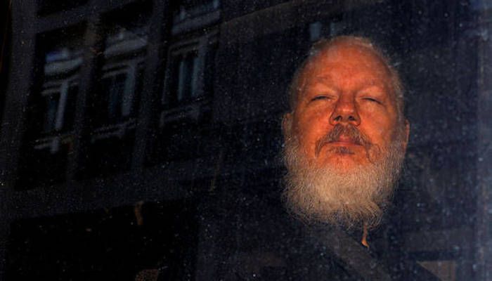 WikiLeaks founder Julian Assange is seen in a police van, after he was arrested by British police, in London, Britain Apr 11, 2019. Photo: REUTERS