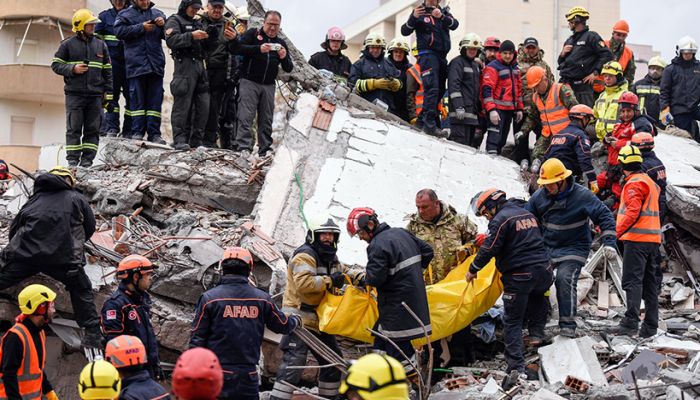 Rescue teams and firefighters carry a victim found under the rubble of a collapsed building in the town of Durres, western Albania on November 28, 2019, after the strongest earthquake in decades hit the country. Photo: AFP

 
 