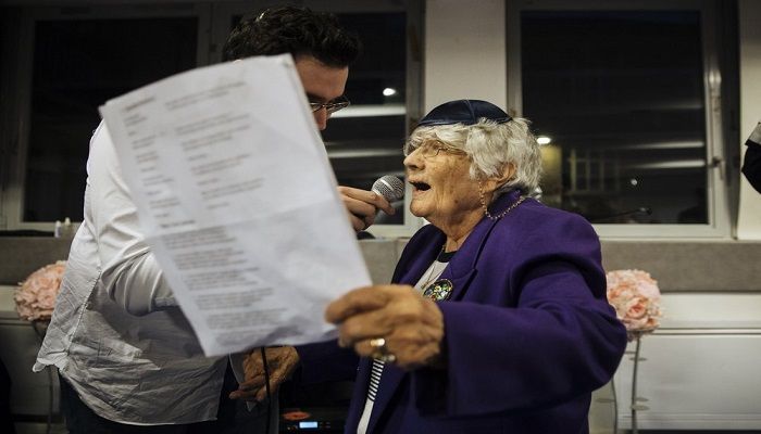 A holocaust survivor sing during an event named 'Survivors Night' in Paris, Monday, Dec. 23, 2019. Holocaust survivors in several cities around the world are lighting candles for Hanukkah together, as Jewish community leaders try to keep first-hand memories of the Nazi horrors alive. The events were organized by the Conference on Jewish Material Claims Against Germany. Photo: AP