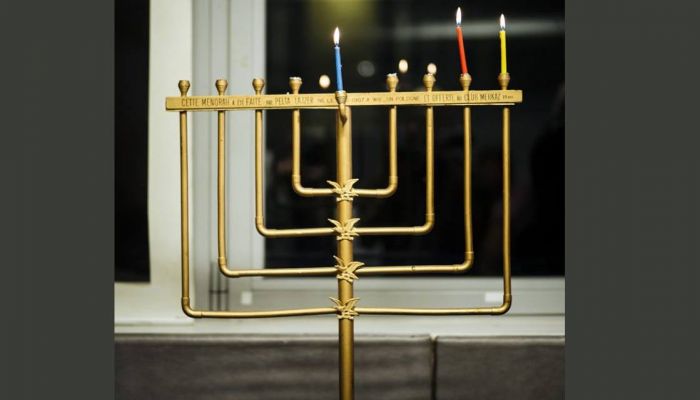 A menorah is seen during an event named 'Survivors Night' in Paris, Monday, Dec. 23, 2019. Holocaust survivors in several cities around the world are lighting candles for Hanukkah together, as Jewish community leaders try to keep first-hand memories of the Nazi horrors alive. The events were organized by the Conference on Jewish Material Claims Against Germany. Photo: AP