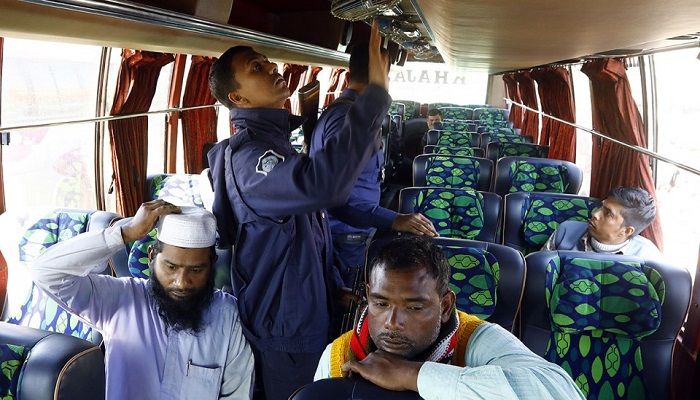 The photo shows that a policeman are cheeking a Dhaka-bound bus in Aminbazar on Dhaka-Aricha highway on Thursday, on December 5, 2019. Photo: Collected