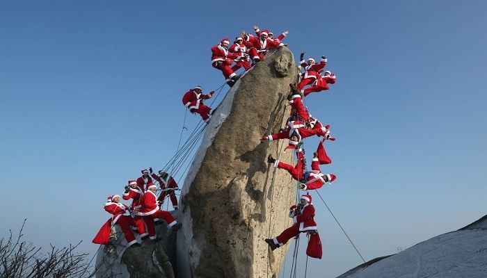 Mountain climbers in Santa Claus outfits pose during an event in support of safe climbing and charitable causes on the Buckhan mountain in Seoul, South Korea. Photo: AHN YOUNG-JOON/AP