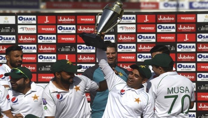 Pakistan's cricketer Abid Ali (2R) holds a trophy along with captain Azhar Ali (3L) after winning their second Test cricket match against Sri Lanka at the National Cricket Stadium in Karachi on Monday- AFP photo