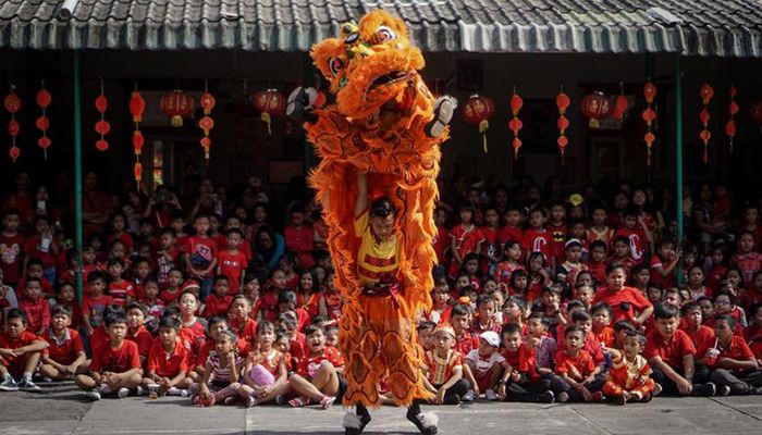 People perform a traditional Chinese lion dance to introduce Chinese culture ahead of Chinese Lunar New Year Celebration in Solo, Central Java, Indonesia.