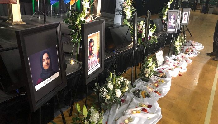 Photos of the victims are seen in front of the stage before the start of a memorial service for the Ukrainian Airlines flight PS752 who crashed in Iran at the Saville Community Sports Centre in Edmonton, Canada on January 12, 2020. Photo: AFP