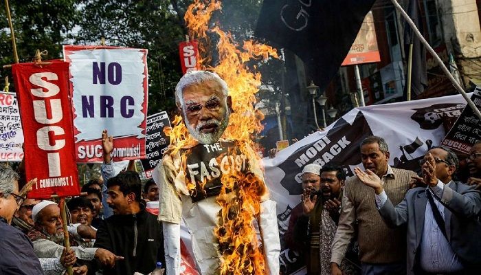 Members and activists Socialist Unity Center of India-Marxist (SUCI-M) burn an effigy of Indian Prime Minister Narendra Modi while protesting against a new citizenship law and Prime Minister Narendra Modi's visit, in Kolkata, India. AP File Photo