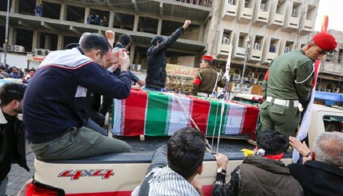 Mourners surround a car carrying the coffin of Qasem Soleimani. Photo: AFP