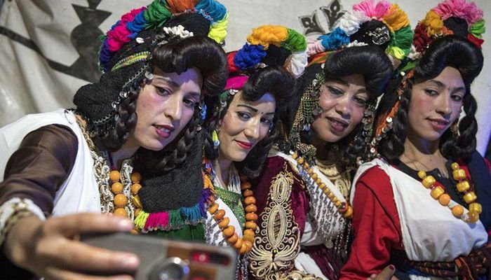 At a wedding festival in central Morocco in September, Amazigh women pose for selfies. The Amazigh are the indigenous people of North Africa, and are pushing for greater recognition of their language and culture. Photo: BBC