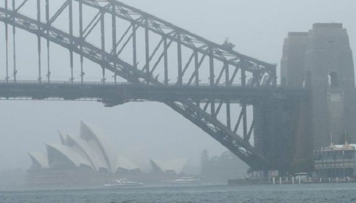 The Sydney Opera House and Sydney Harbour Bridge seen through a cloak of heavy rain. Photo: Collected from BBC