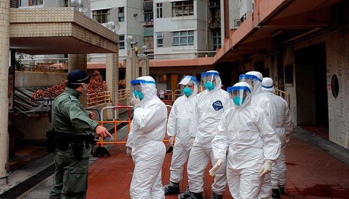 Police in protective gear wait to evacuate residents from a public housing building, following the outbreak of the novel coronavirus, in Hong Kong, China on 11 February 2020. Photo: Collected from Reuters