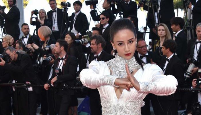 Fist and palm salute: 
In China, where the COVID-19 outbreak began, one greeting recommendation is the traditional gong shou gesture, or the fist and palm salute, as demonstrated above by actress Miya Muqi at the Cannes screening of "Ash Is The Purest White" in 2018.