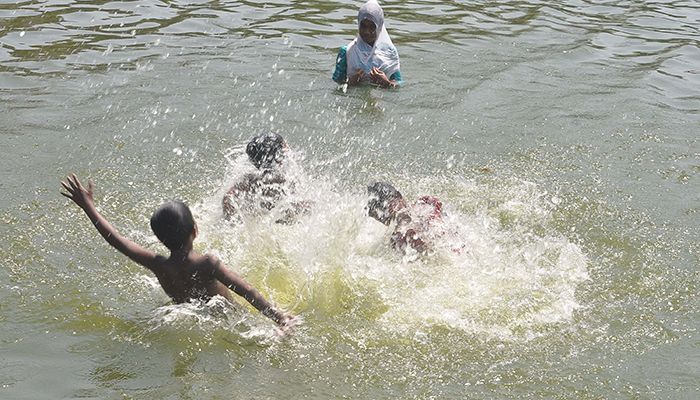 Children and teenagers are enjoying the pond at the very beginning of the last month of the Bangla calendar. The photo was taken from Agrabad area of Chittagong city.