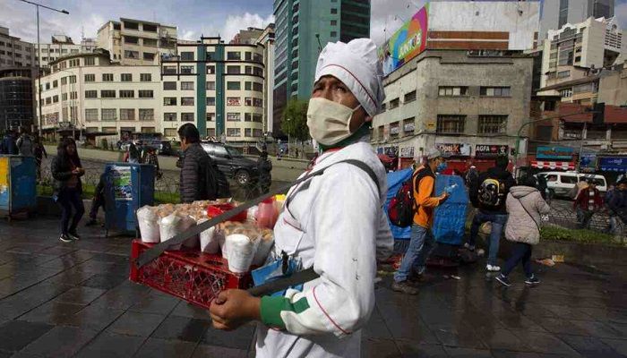 A fried chicken vendor wears a face mask as a preventative measure against the spread of the new coronavirus, in La Paz, Bolivia, Wedensday, March 18, 2020. Photo: Collected from AP