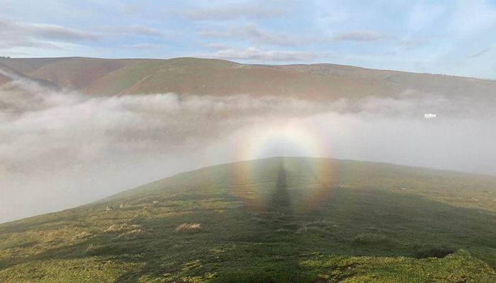 A Brocken spectre appears on the Stretton Hills, Shropshire, by Weather Watcher Snapper Simon. The optical phenomenon happens when an observer stands above cloud or mist - on a mountain or high ground - with the sun behind them, causing a large shadow to be cast. The circular, rainbow-like 'glory' is created by the sun interacting with water particles in the air.