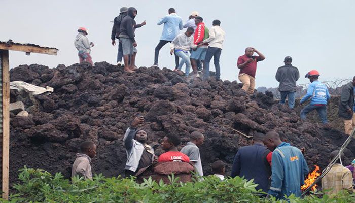 People gather on a stream of cold lava rock in DR Congo || Photo: Collected 