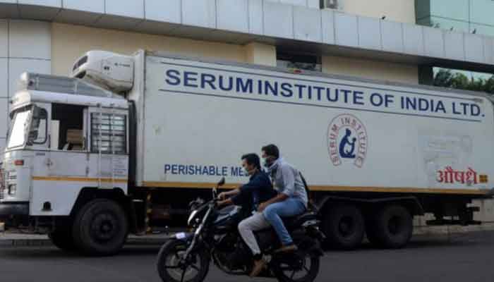 Men ride on a motorbike past a supply truck of India's Serum Institute, the world's largest maker of vaccines, which is working on a vaccine against the coronavirus disease (COVID-19) in Pune, India, May 18, 2020. Reuters file photo (Collected) 