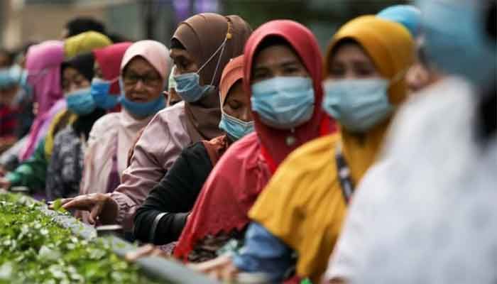 Passengers wearing protective masks wait in line at a bus station, amid the Covid-19 outbreak in Kuala Lumpur, Malaysia August 11, 2020 || Photo: Reuters