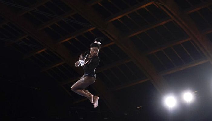 (Tokyo, Japan) US gymnast Simone Biles trains on the uneven bars during a practice session at the 2020 Olympics. (Photograph: Gregory Bull/AP)