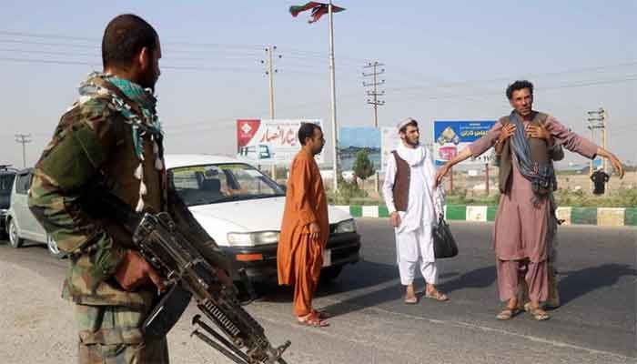 Afghan soldiers search a man at a checkpoint in Herat province. The army has lost ground to the Taliban. || Photo: Reuters