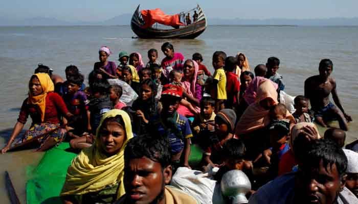 File Photo: Rohingya refugees sit on a makeshift boat as they get interrogated by the Border Guard Bangladesh after crossing the Bangladesh-Myanmar border, at Shah Porir Dwip near Cox's Bazar, Bangladesh November 9, 2017. || Photo: REUTERS