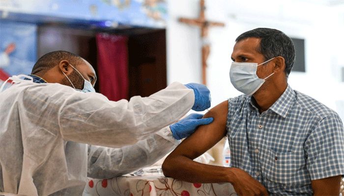A man receives a dose of a vaccine against the coronavirus disease at St Paul's Church in Abu Dhabi, United Arab Emirates, January 16, 2021. || Reuters Photo: Collected  