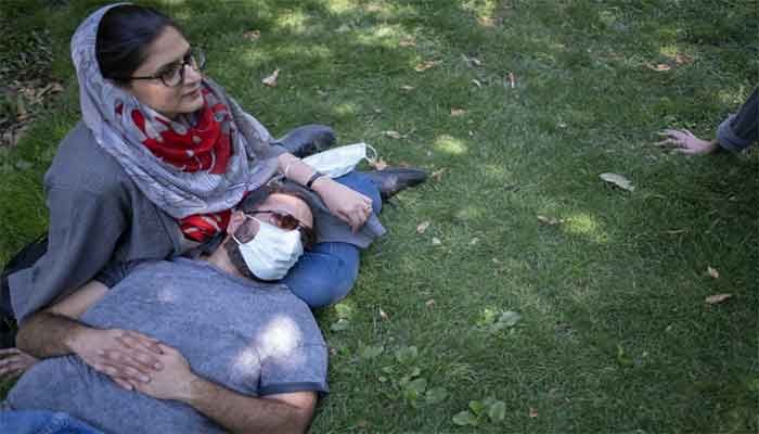 An Iranian couple rest at a park in northern Tehran on May 28, 2021. Iran on July 12, 2021 unveiled an Islamic dating app called Hamdam that allows users to "search for and choose their spouse," state television reported. ||Photo: AFP 