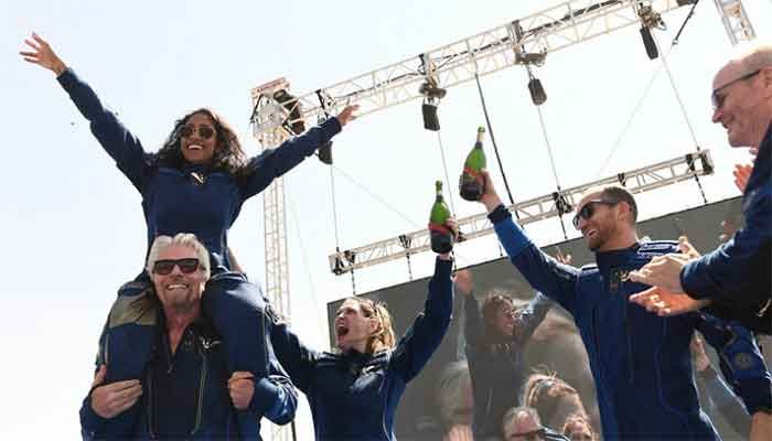 Virgin Galactic founder Sir Richard Branson (left), with Sirisha Bandla on his shoulders, cheers with crew members after flying into space aboard a Virgin Galactic vessel near Truth and Consequences, NM, on July 11, 2021. || Photo: AFP