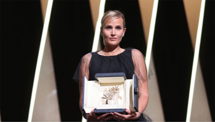 French director Julia Ducournau poses on stage with her trophy after she won the Palme d'Or for her film "Titane" during the closing ceremony of the 74th edition of the Cannes Film Festival in Cannes, southern France, on July 17, 2021. || AFP Photo: Collected