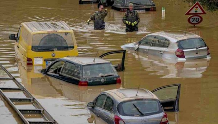 People check for victims in flooded cars on a road in Erftstadt, Germany, following heavy rainfall that broke the banks of the Erft river, causing massive damage, July 17, 2021. || AP Photo: Collected