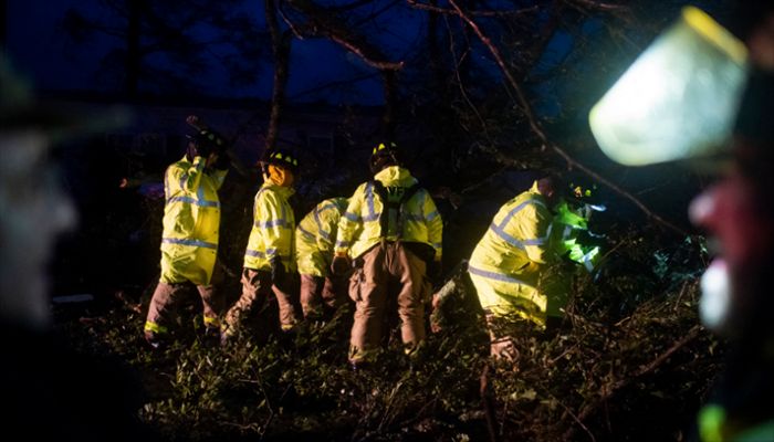Montegut and Bourg firefighters cut through trees on the road in Bourg, Louisiana as Hurricane Ida passes on August 29, 2021. || AFP Photo: Collected
 