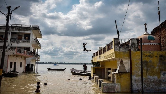 (Allahabad, India) A child jumps into the water after rising levels in the rivers caused flooding in the Jhusi area (Photograph: Sanjay Kanojia/AFP/Getty Images)