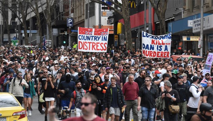 Protesters march through the streets during an anti-lockdown rally in Melbourne on August 21, 2021. || AFP Photo: Collected  