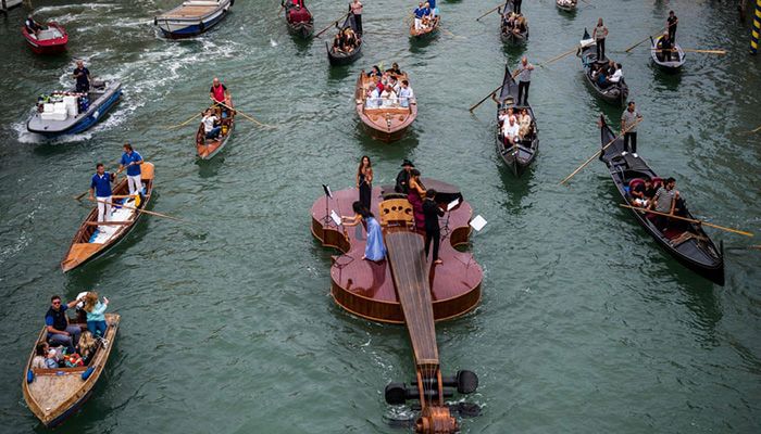 (Venice, Italy) Noah’s Violin, a giant floating artwork by the Venetian sculptor Livio De Marchi, makes its maiden voyage on the Grand Canal. The makers said it symbolised the rebirth of Venice through art, culture and music || Photograph: Marco Bertorello/AFP/Getty Images