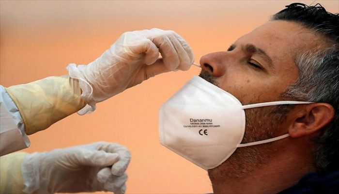A healthcare worker takes a swab sample from a man to be tested for Covid-19 during a massive test in the small Andalusian village of Arriate, Spain November 7, 2020. || Reuters Photo: Collected