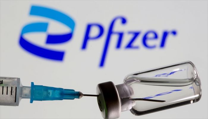 Syringe and vial are seen in front of displayed new Pfizer logo in this illustration taken, June 24, 2021. || Reuters Photo: Collected