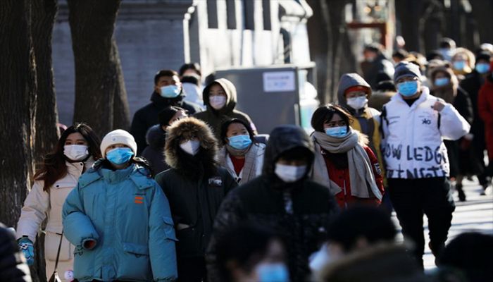 People wearing protective face masks walk along Nanluoguxiang alley, following Covid-19 outbreak, in Beijing, China, January 16, 2021. || Reuters Photo: Collected