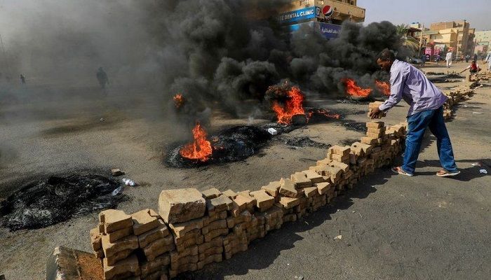 Demonstrators block roads in the capital, Khartoum, in protest at the arrests