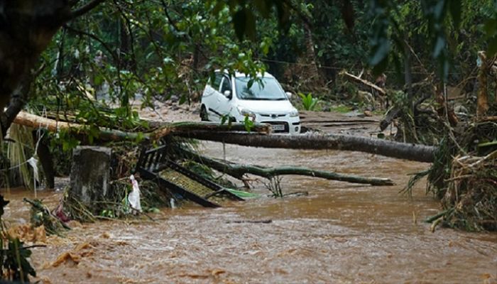 A car stucked in mud waters is pictured after flash floods caused by heavy rains at Thodupuzha in India’s Kerala state on October 16, 2021. || AFP Photo: Collected 