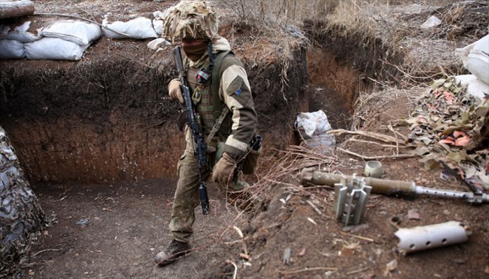 A Ukrainian serviceman walks along a trench on the frontline with Russia-backed separatists not far from Gorlivka, Donetsk region, on November 26, 2021. || AFP Photo: Collected 