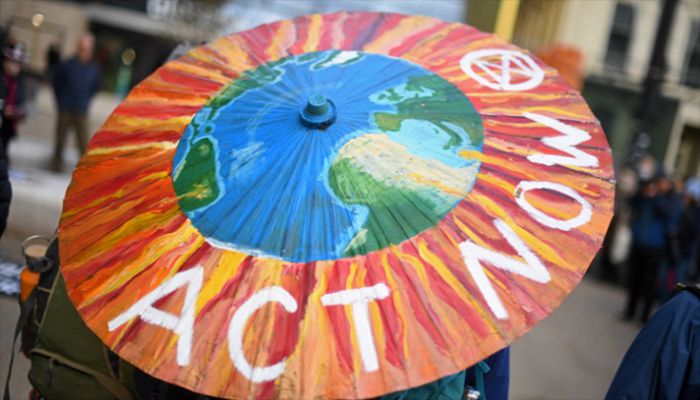 A protester holds a painted parasol in George Square ahead of a protest by Climate activist group Extinction Rebellion in Glasgow on November 7, 2021, during the COP26 UN Climate Change Conference. || AFP Photo: Collected 