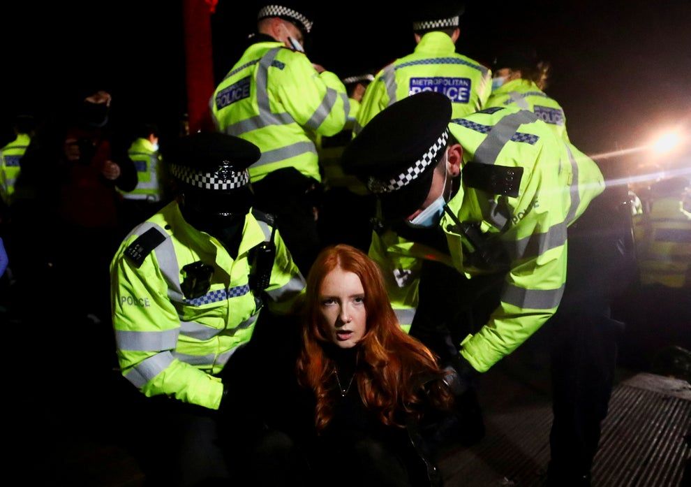 13th March 2021 || Police detain a woman as people gather at a memorial site in Clapham Common Bandstand, following the kidnap and murder of Sarah Everard, in London || Hannah McKay /Reuters