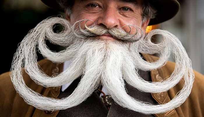 Participant Norbert Dopf from Austria arrives for the German Moustache and Beard Championships 2021 at Pullman City Western Theme Park in Eging am See, Germany, October 23. || Photo: REUTERS